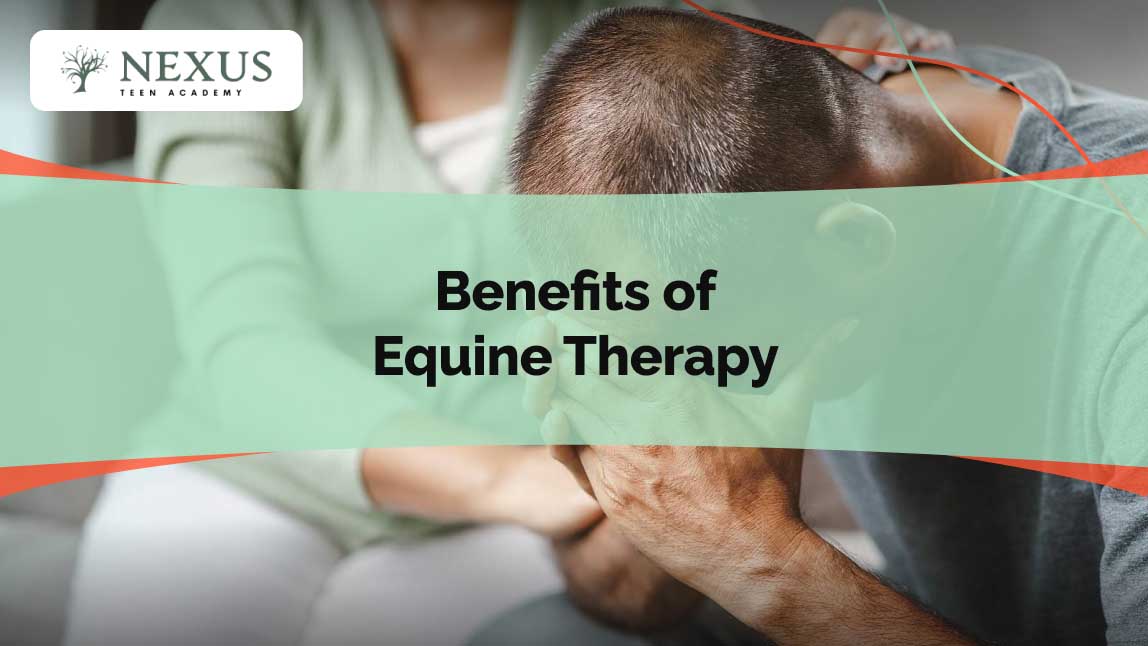 A distressed man sits with his head in his hands while a therapist provides support, representing the emotional healing benefits of equine therapy.