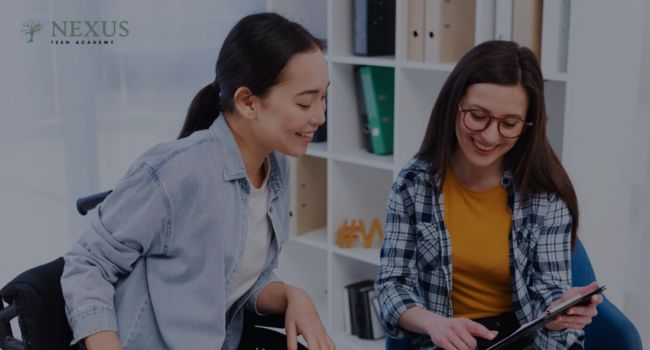 Two teenagers smiling and discussing together in a comfortable setting, emphasizing the importance of therapy for teens to improve emotional well-being and develop coping mechanisms for challenges.