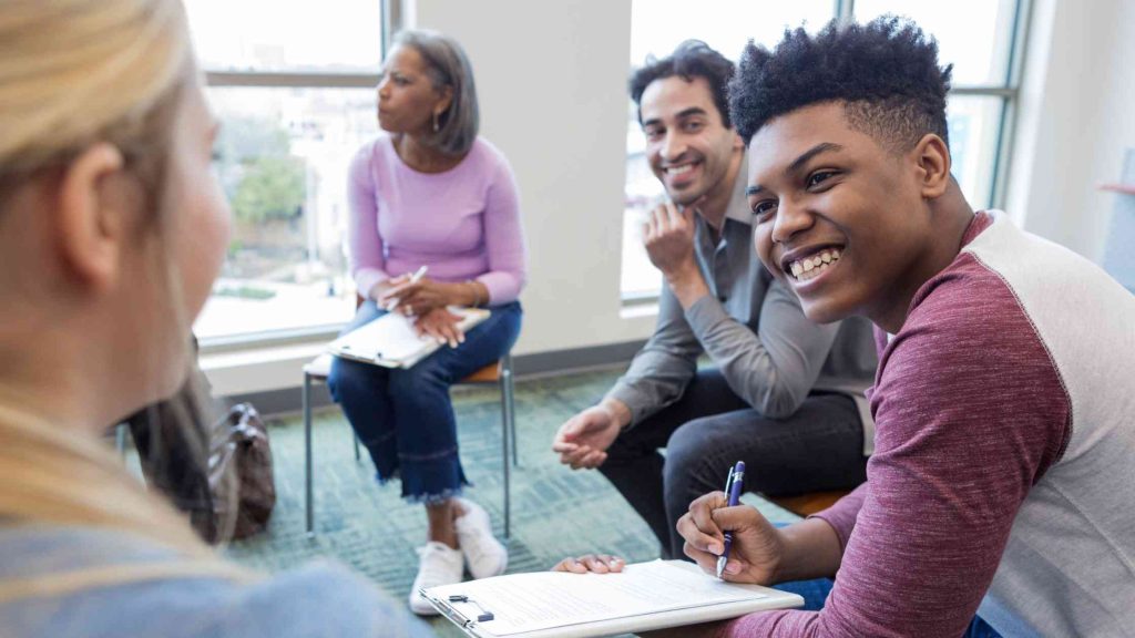 Teens engaged in a psychodrama therapy session, participating in role-playing exercises to explore emotions, improve communication, and support mental health.