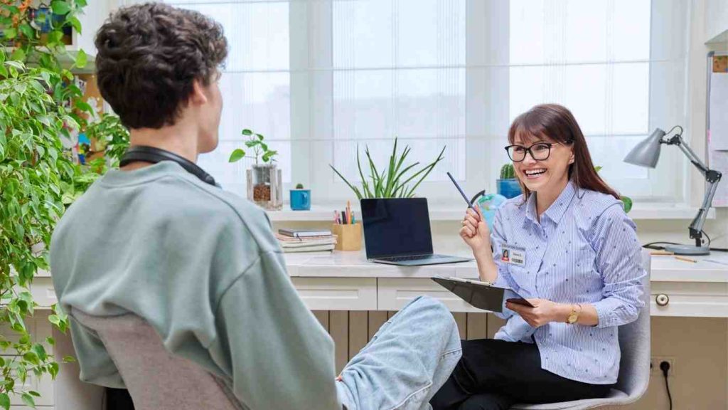 A therapist engaging with a teen during a session at Nexus Teen Academy, focusing on psychosis treatment. The environment promotes recovery, offering supportive care for mental health and independence.