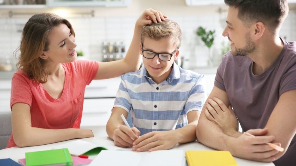 A supportive family engages in a therapeutic activity with a teen, fostering trust and honesty. The parents encourage open communication and self-reflection in a warm environment.