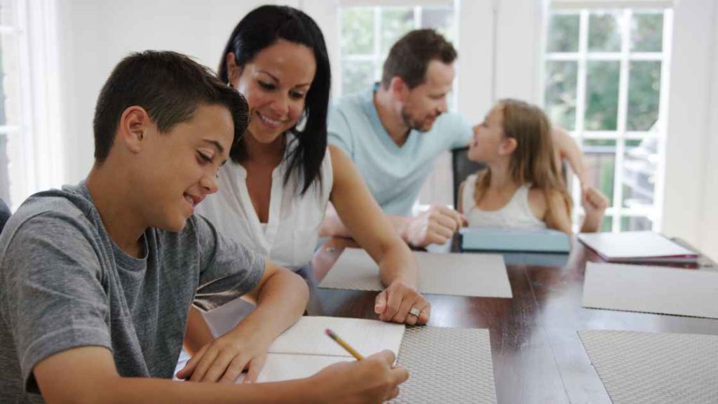 A supportive family interacting with their children at home, reflecting the nurturing environment and structured daily routines expected during inpatient treatment for teenage PTSD.