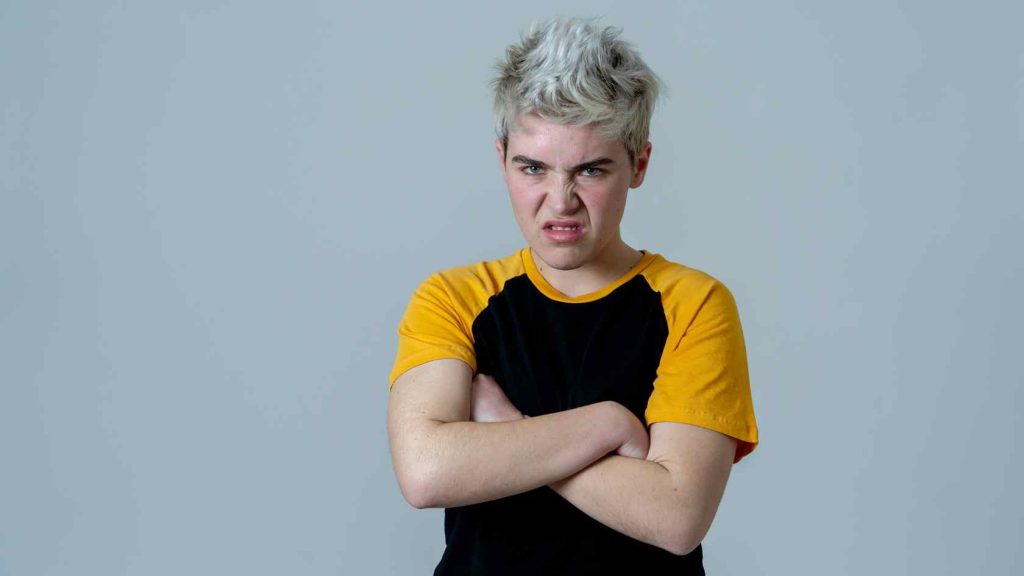 Teen displaying intense anger and defiance, a potential sign of anger disorders that may require inpatient treatment.