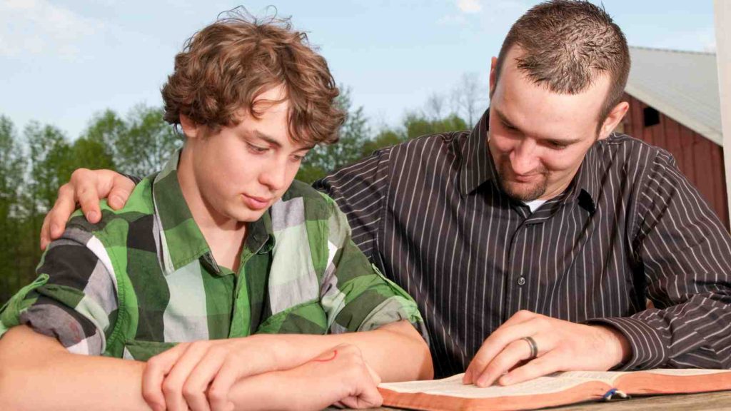 Supportive adult guiding a teen through reading or therapy, symbolizing treatment options for behavioral health issues.