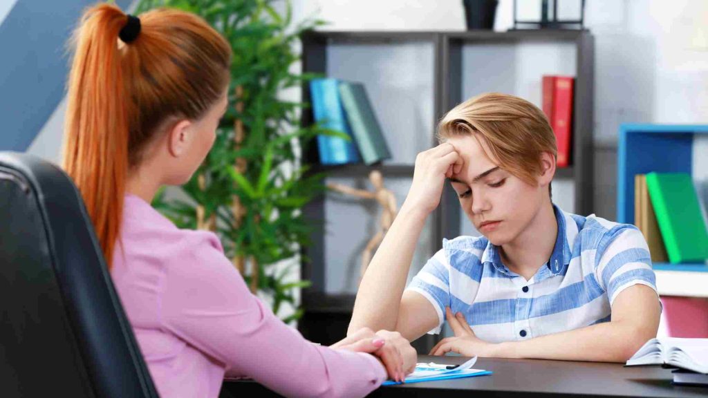 Counselor supporting a stressed teen during a session, illustrating early intervention and support strategies for youth.