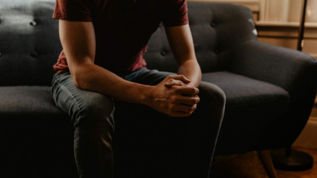 A teen sitting on a couch, symbolizing the early moments before seeking support resources for teen substance concerns.