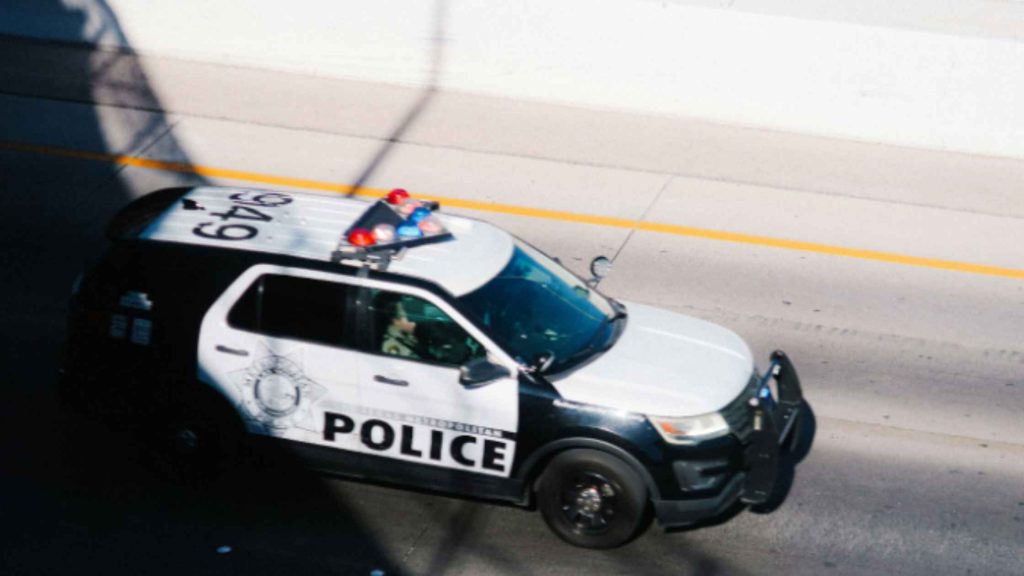 Police SUV driving on the road, representing a teen crisis incident where parents consider residential treatment options.