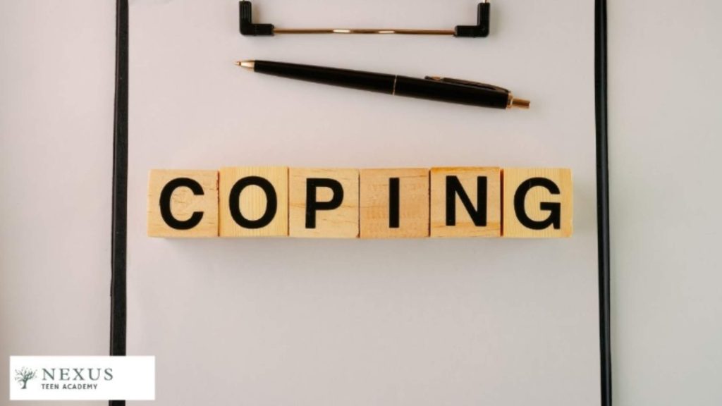 Wooden blocks spelling “COPING” with a pen on a clipboard, symbolizing “Strategies to Cope with Intense Emotions.”